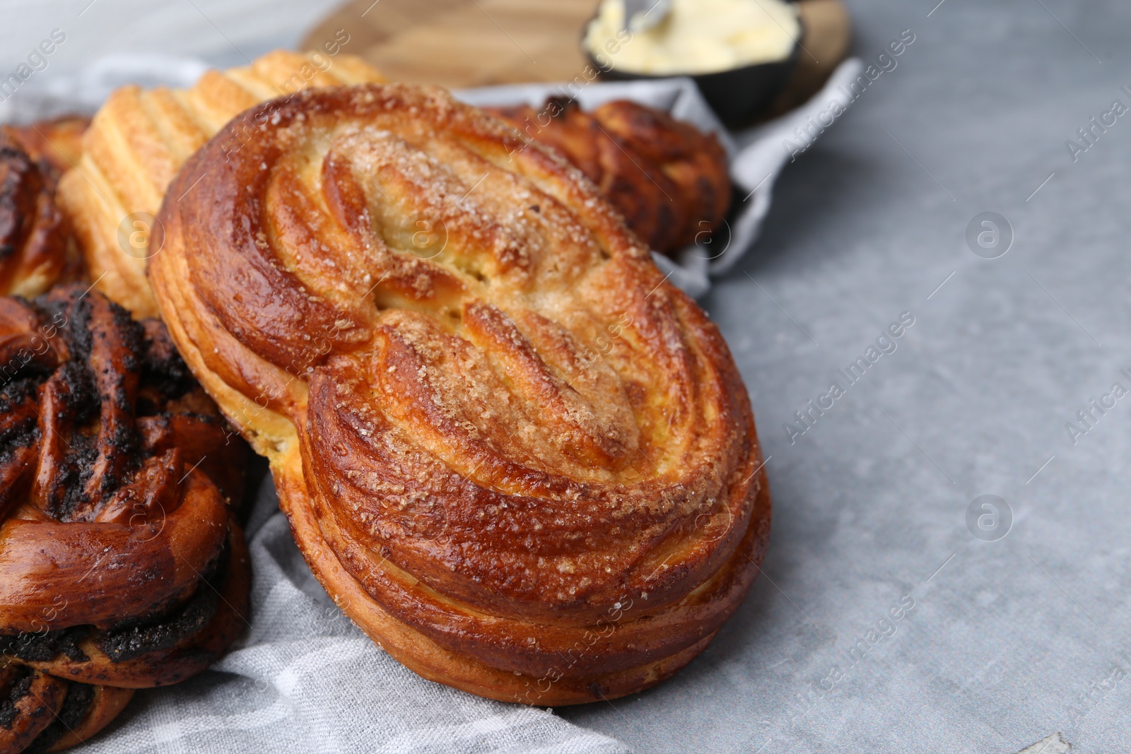 Photo of Different delicious pastries on grey table, closeup. Space for text