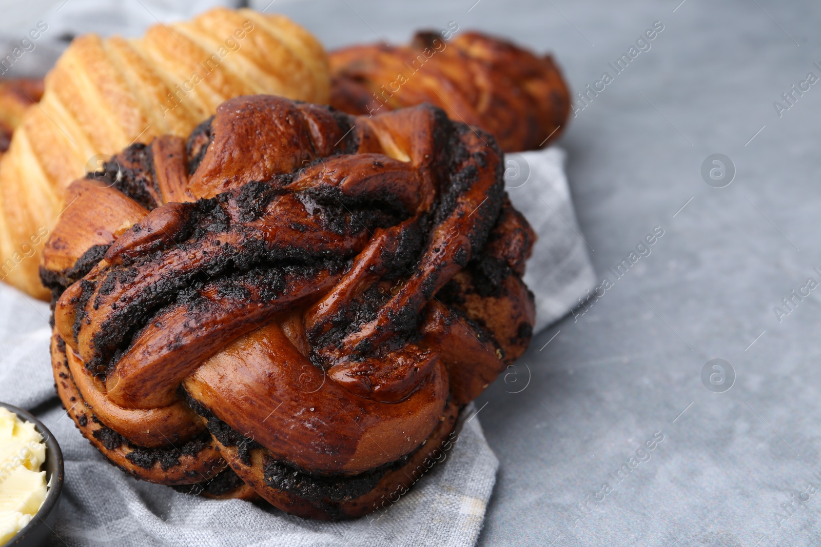 Photo of Different delicious pastries on grey table, closeup. Space for text