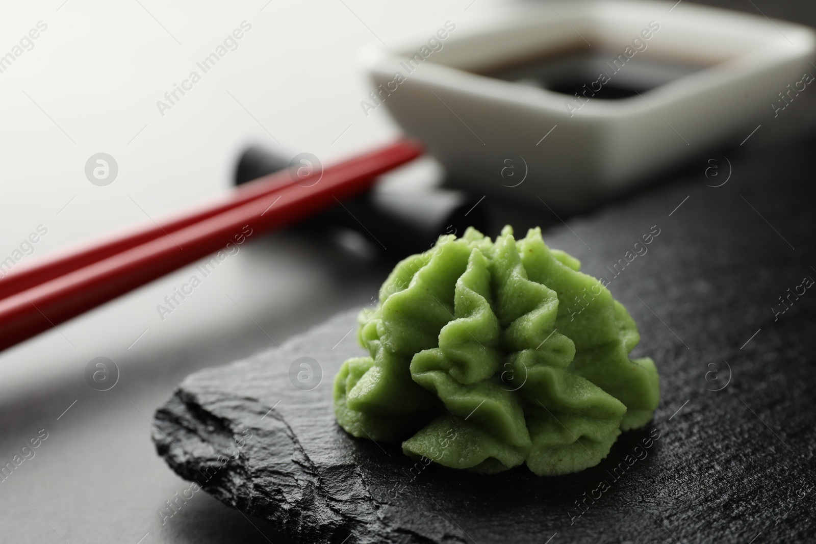 Photo of Hot wasabi paste on grey table, closeup