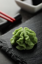 Photo of Hot wasabi paste on grey table, closeup