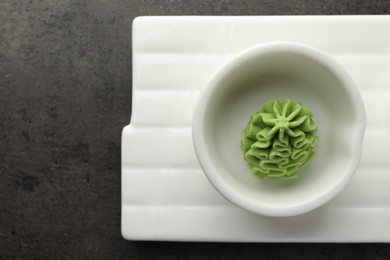 Photo of Hot wasabi paste on grey table, top view. Space for text