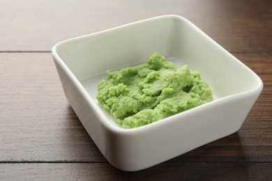 Photo of Hot wasabi paste on wooden table, closeup