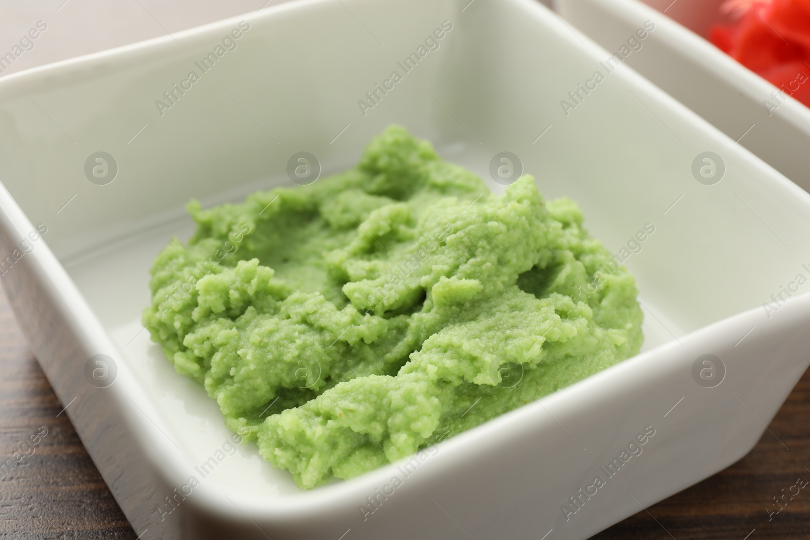 Photo of Hot wasabi paste on wooden table, closeup