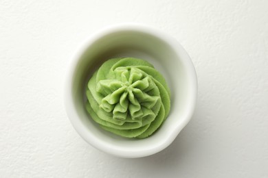 Photo of Hot wasabi paste in bowl on white table, top view