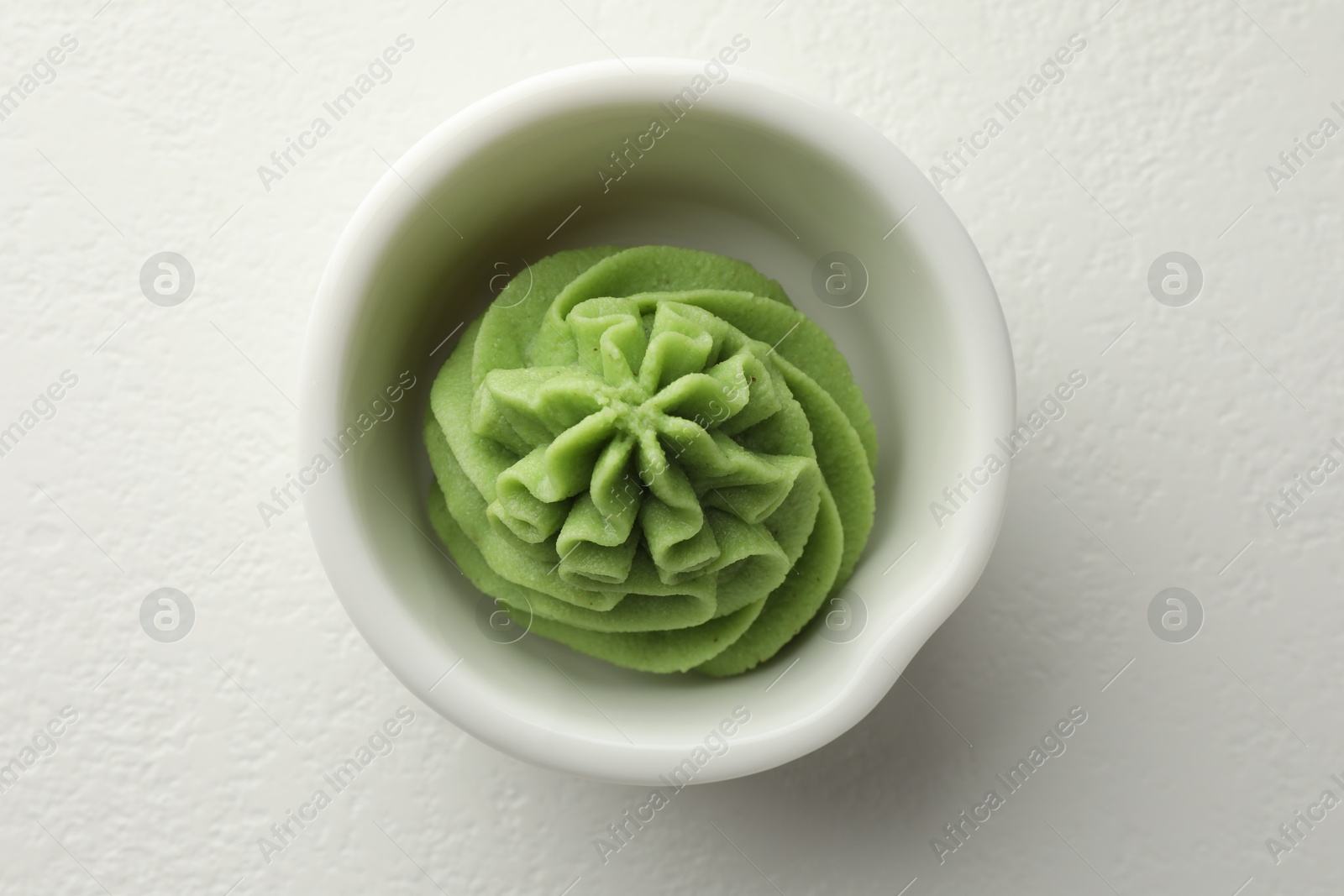 Photo of Hot wasabi paste in bowl on white table, top view