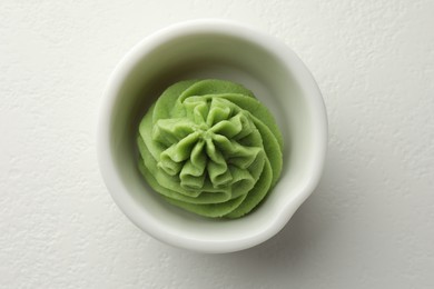 Photo of Hot wasabi paste in bowl on white table, top view