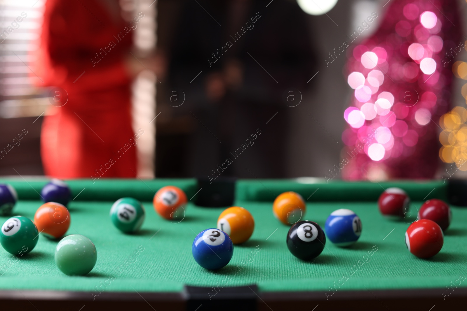 Photo of Many colorful billiard balls on green table indoors, closeup. Space for text