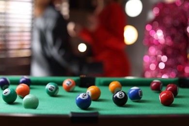 Photo of Many colorful billiard balls on green table indoors, space for text