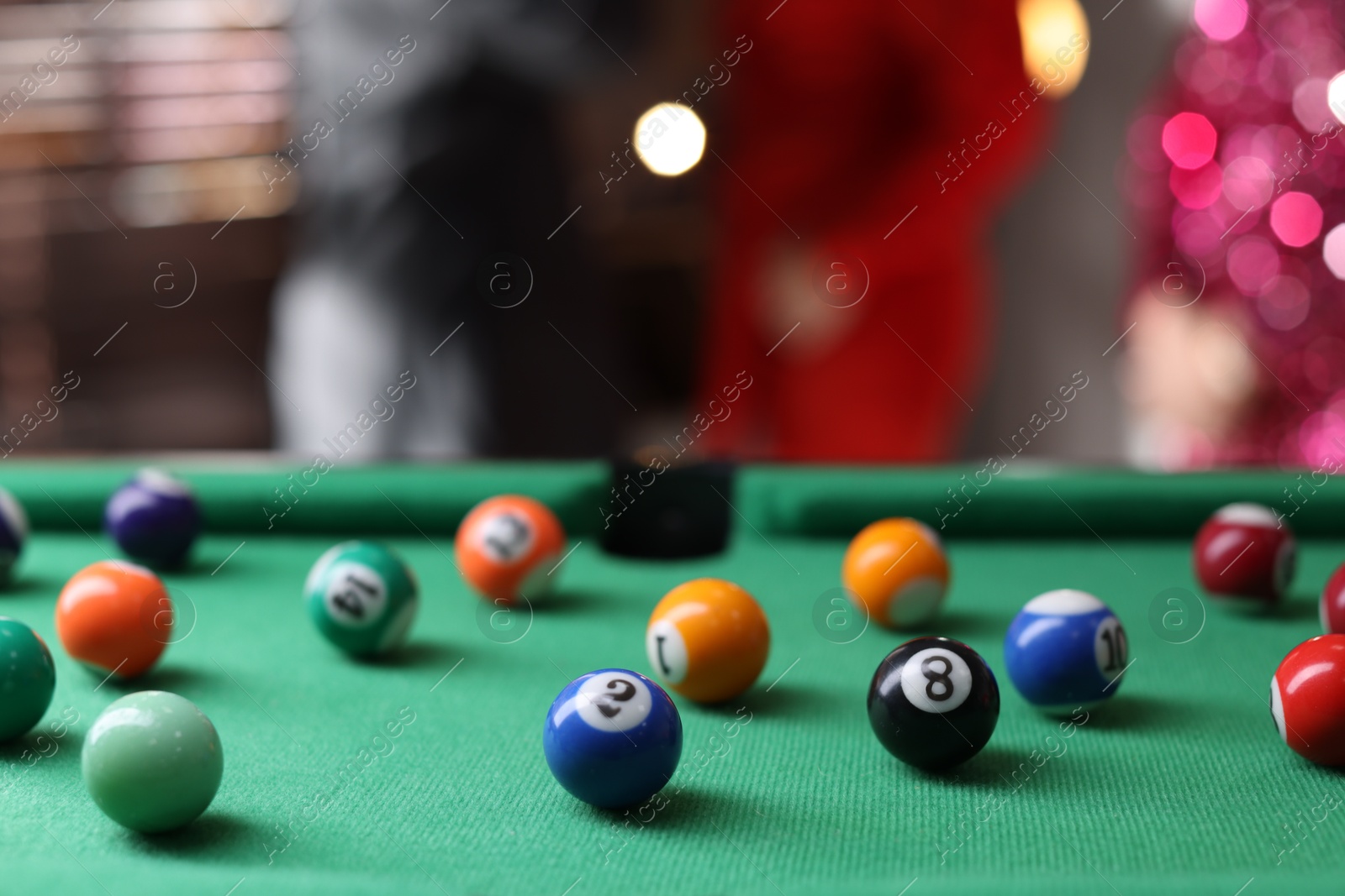 Photo of Many colorful billiard balls on green table indoors, closeup. Space for text