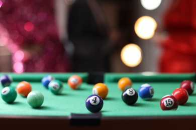 Photo of Many colorful billiard balls on green table indoors, closeup. Space for text