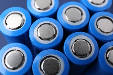 Photo of Many AA cell batteries as background, closeup