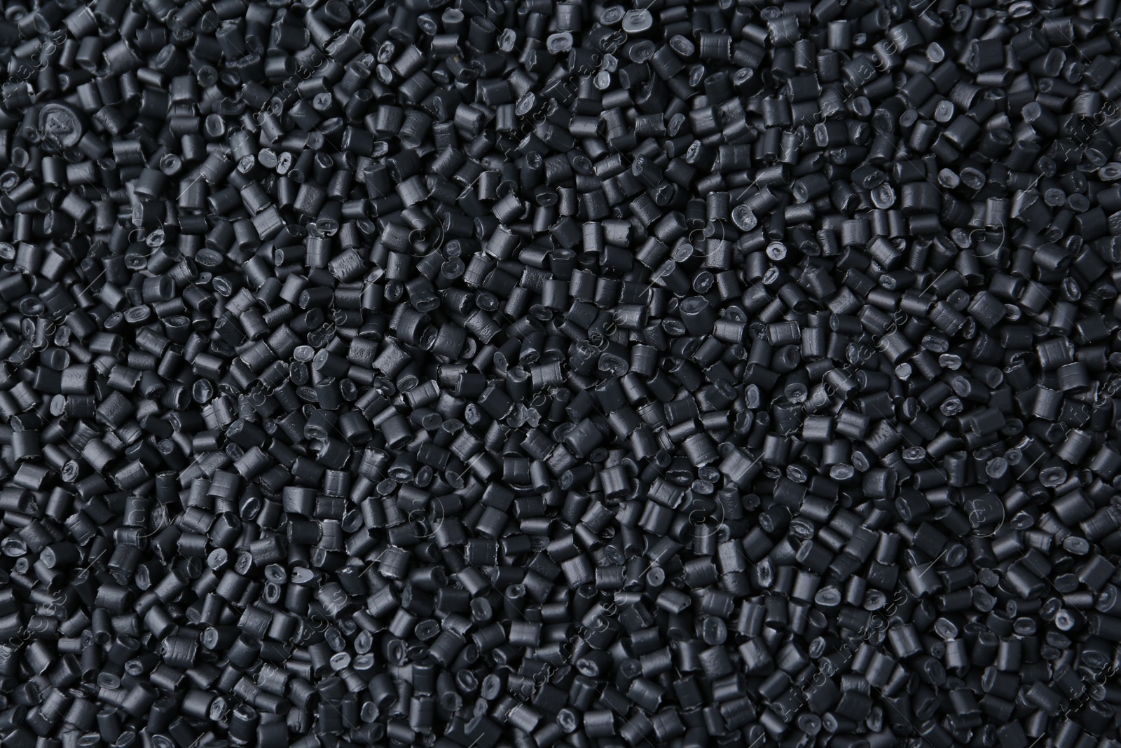 Photo of Pile of black plastic granules as background, top view