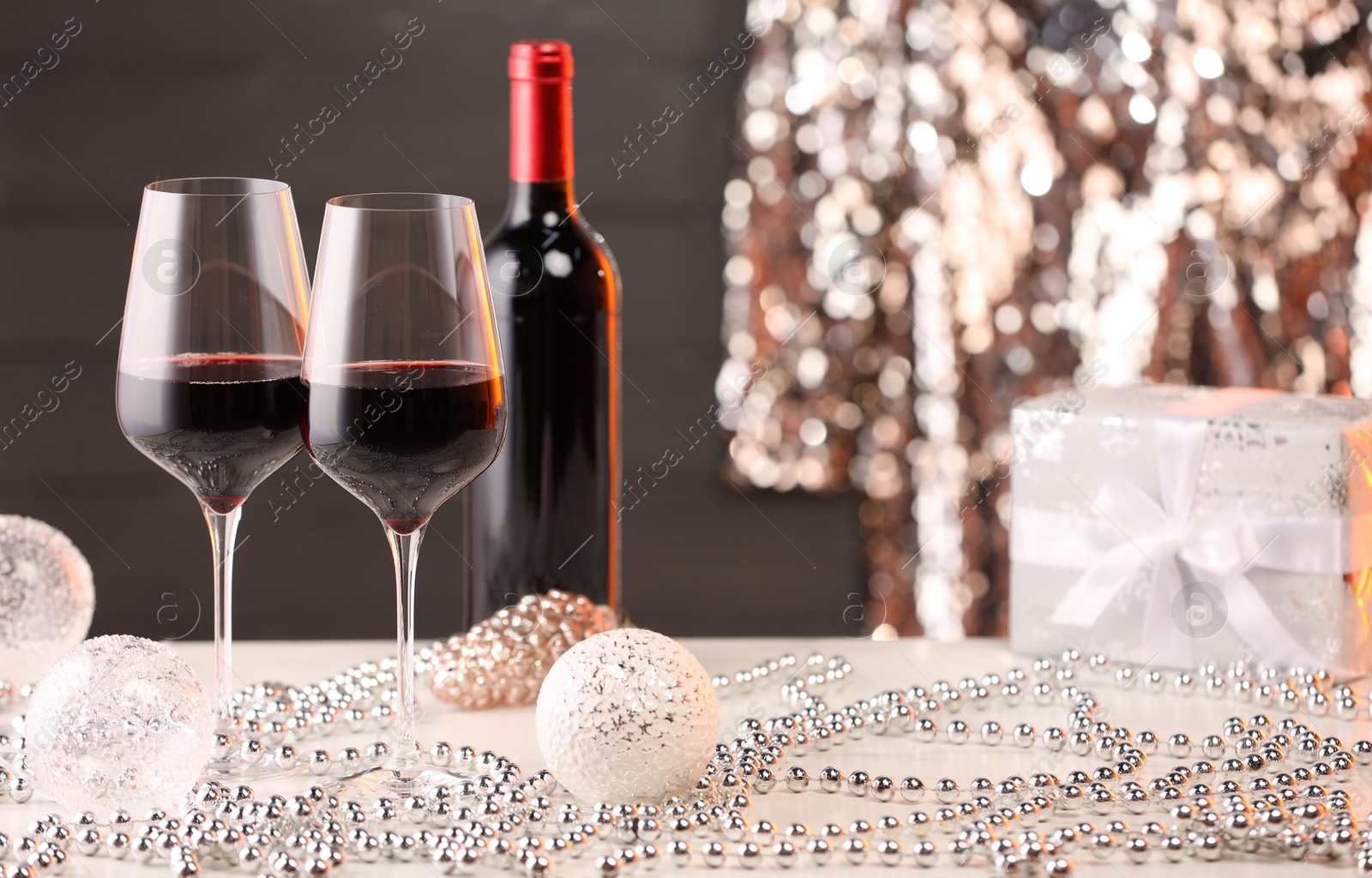 Photo of Red wine and beautiful Christmas decor on white table