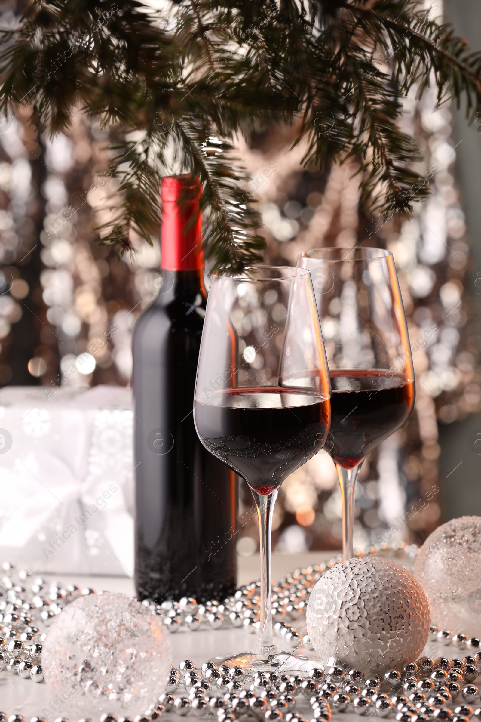 Photo of Red wine and beautiful Christmas decor on white table