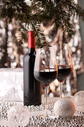 Photo of Red wine and beautiful Christmas decor on white table