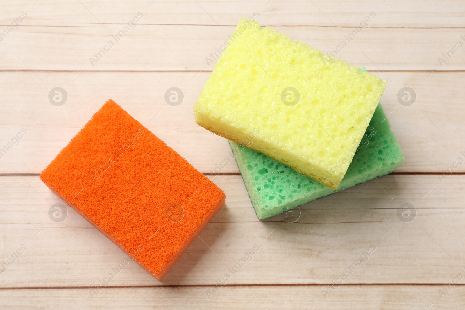 Photo of Soft sponges on wooden table, top view