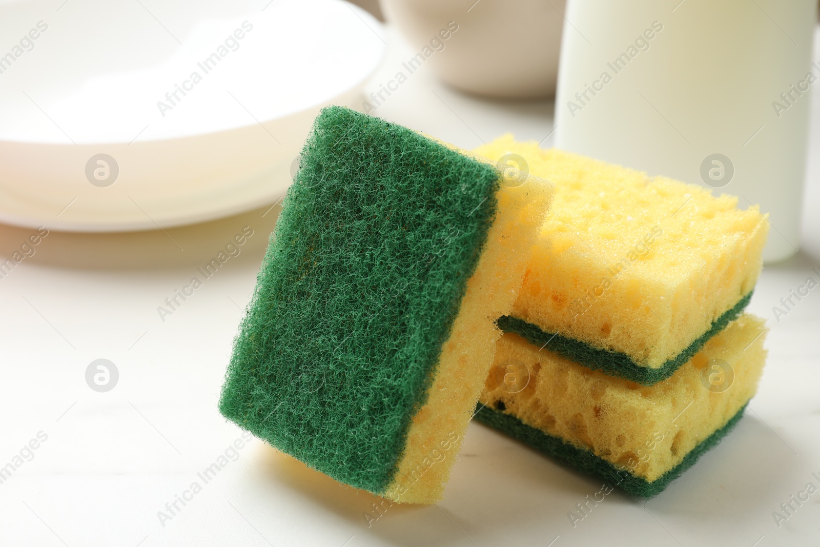 Photo of Many soft sponges on white table, closeup