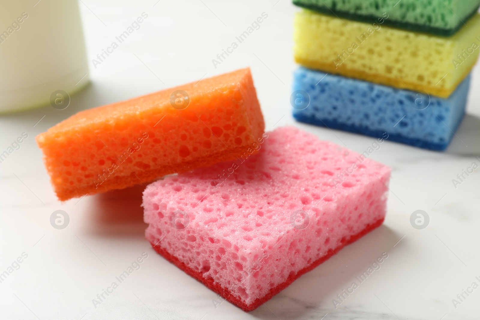 Photo of Many soft sponges on white table, closeup