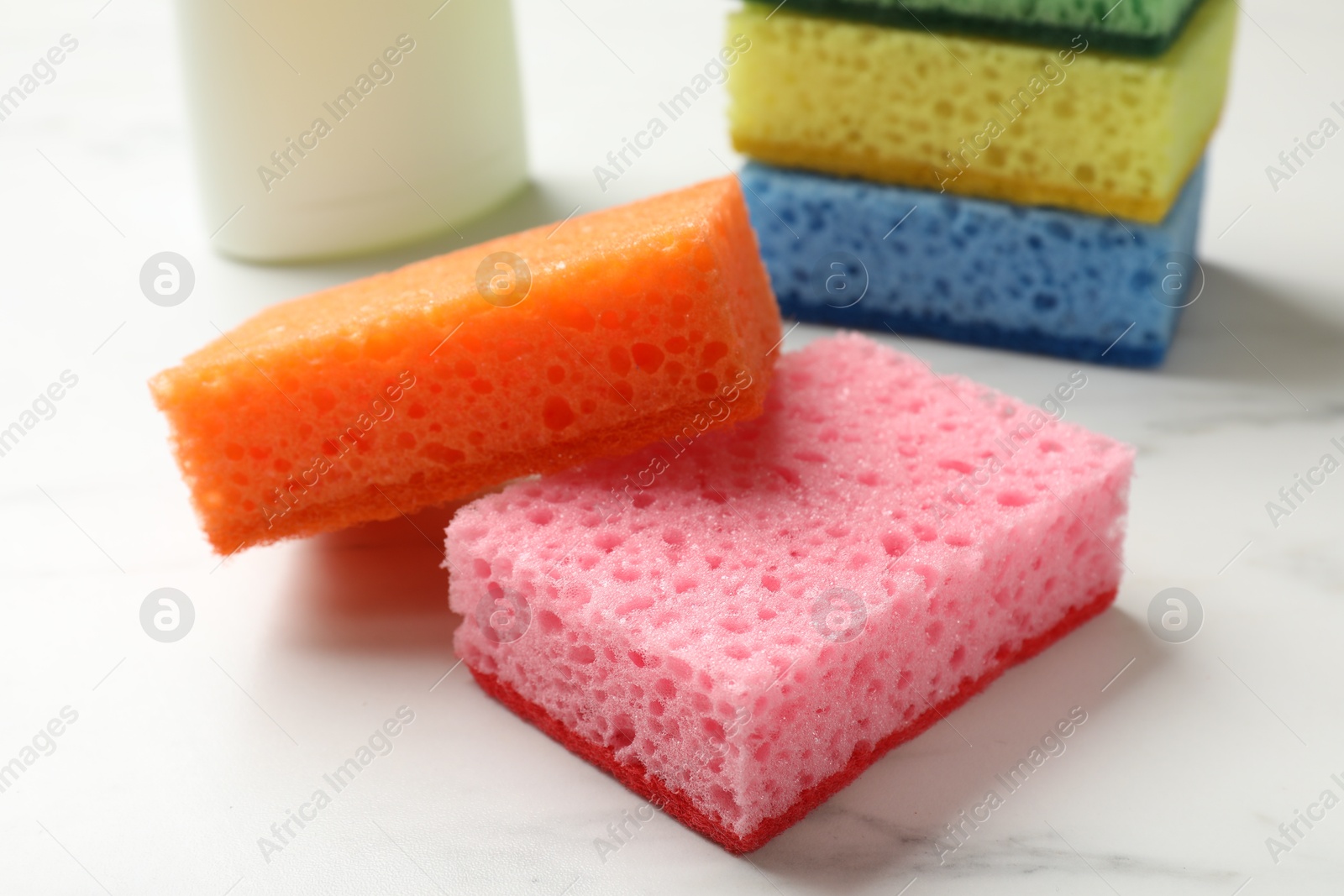 Photo of Many soft sponges on white table, closeup