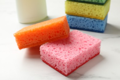 Photo of Many soft sponges on white table, closeup