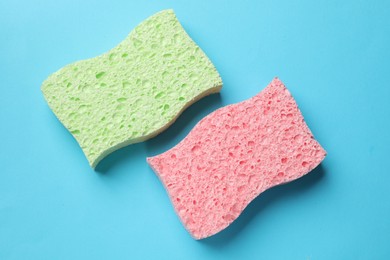 Photo of Soft sponge on light blue background, top view