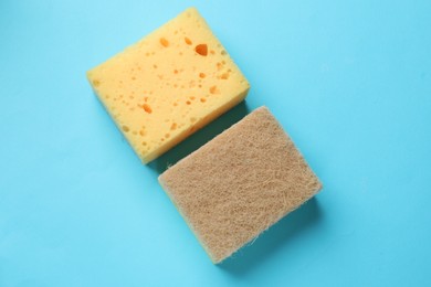 Photo of Soft sponge on light blue background, top view