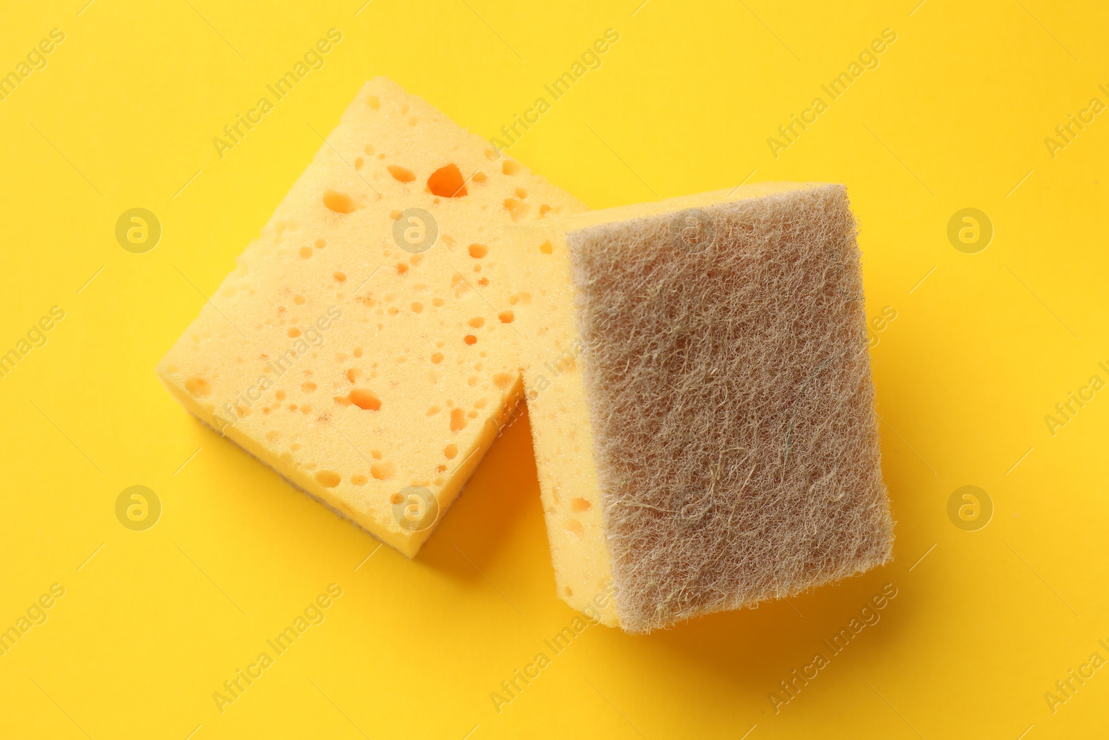 Photo of Soft sponge on yellow background, top view