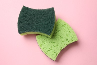 Photo of Green sponges on pink background, top view