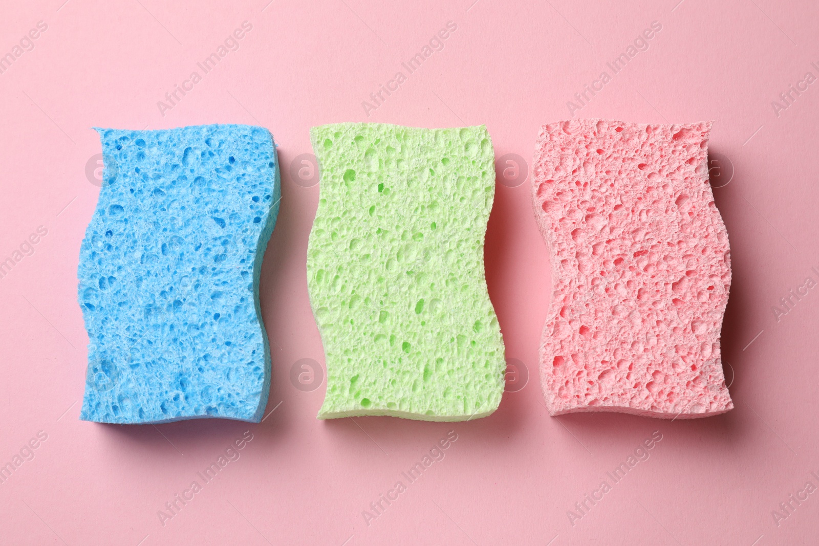 Photo of Soft sponges on pink background, top view