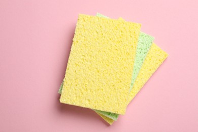 Photo of Soft sponges on pink background, top view