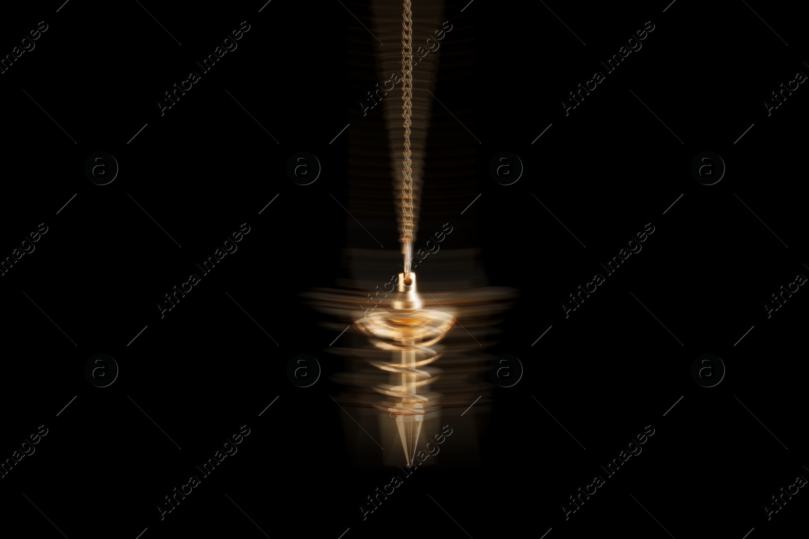 Image of Hypnosis session. Golden pendulum swinging on black background, motion blur effect