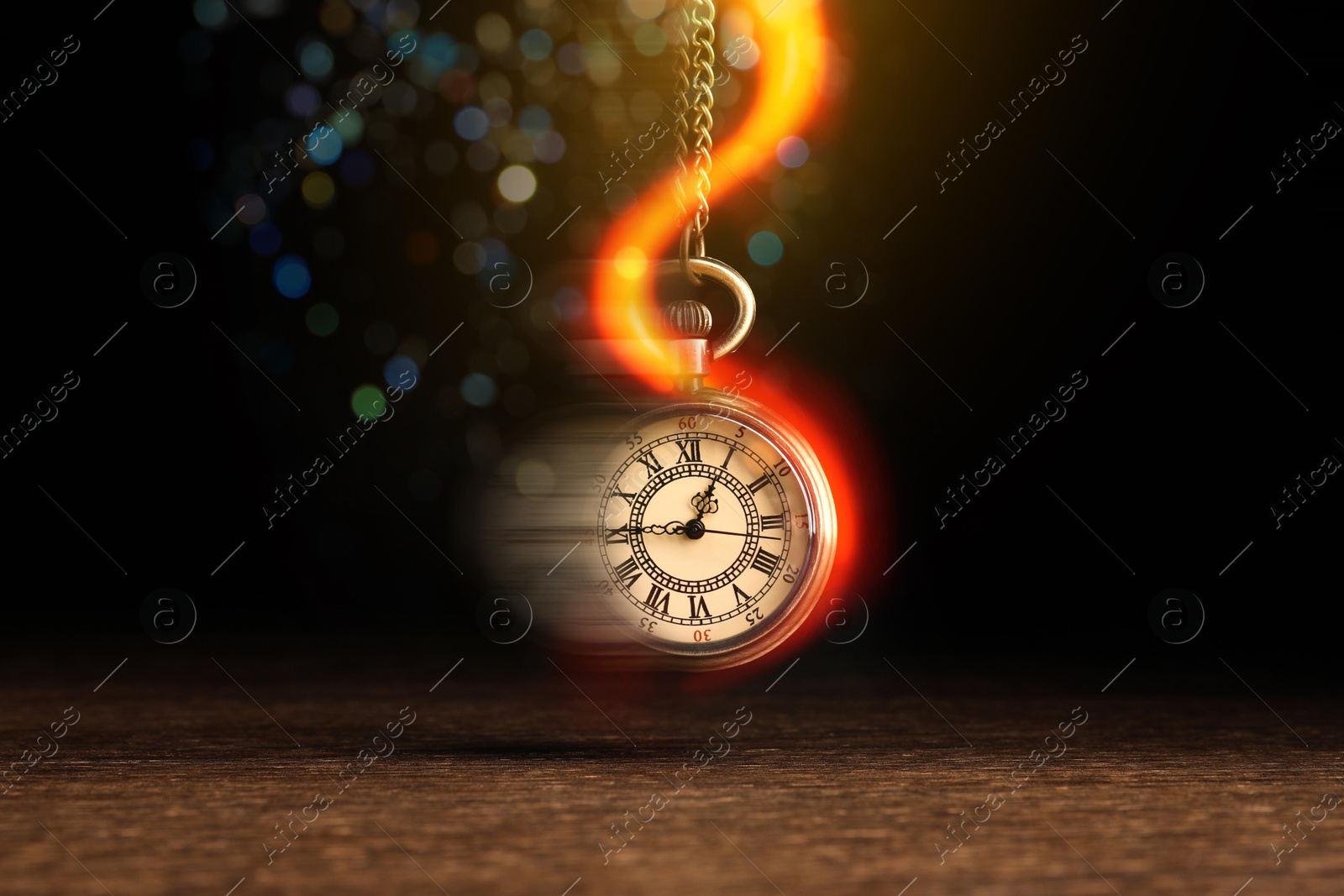 Image of Hypnosis session. Vintage pocket watch swinging on black background, motion blur effect. Magic lights