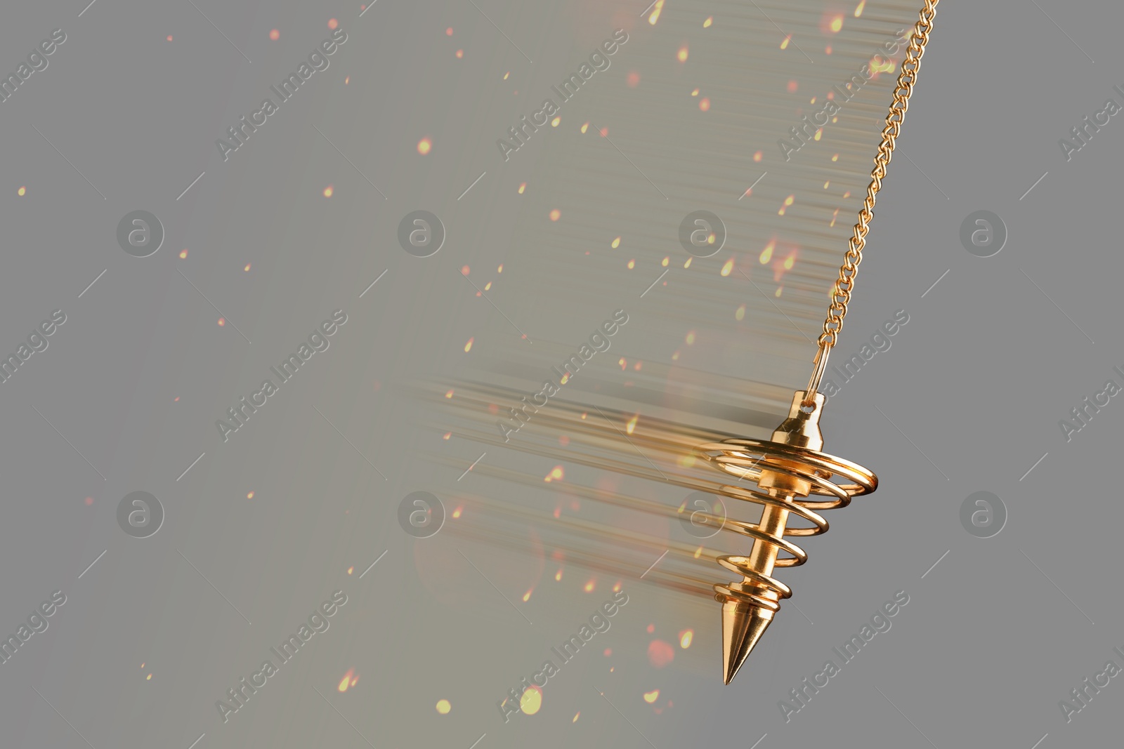 Image of Hypnosis session. Golden pendulum swinging on grey background, motion blur effect. Magic lights