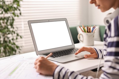 Photo of Woman working at table with laptop in office, closeup. Mockup for design