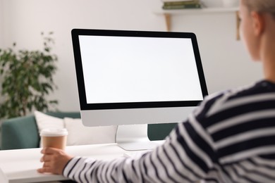 Woman working with computer monitor at table in office, closeup. Mockup for design