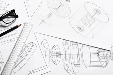 Photo of Different engineering drawings, ruler, pencil and glasses, top view