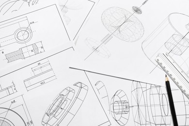 Photo of Different engineering drawings, ruler and pencil, above view