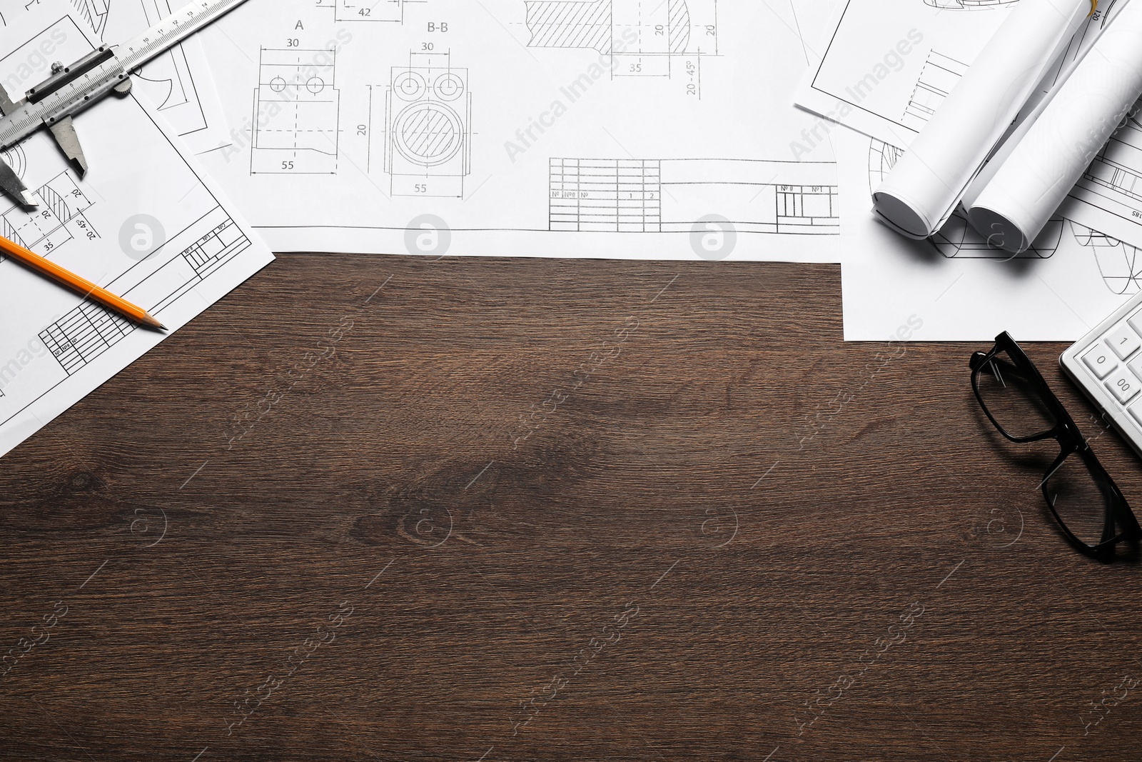 Photo of Different architectural drawings and tools wooden table, flat lay. Space for text