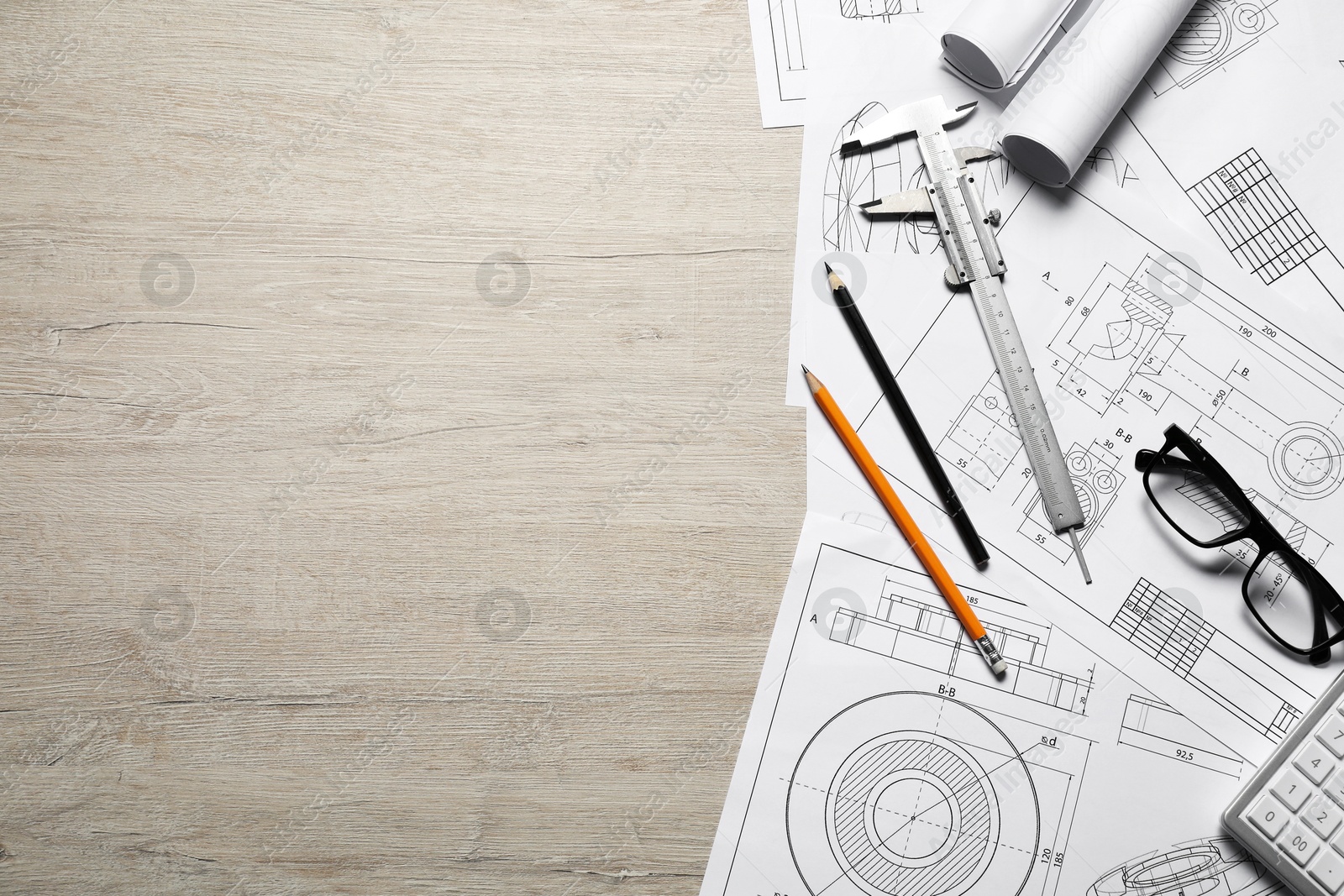 Photo of Different engineering drawings and tools on wooden table, top view. Space for text