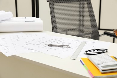 Photo of Different architectural drawings and tools on table in office