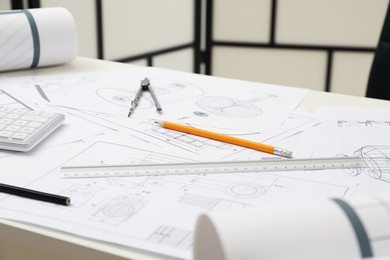 Photo of Different engineering drawings and tools on table in office