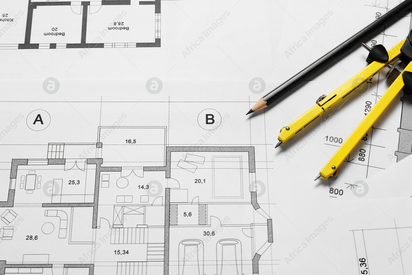 Photo of Different architectural drawings, pencil and divider on table, flat lay