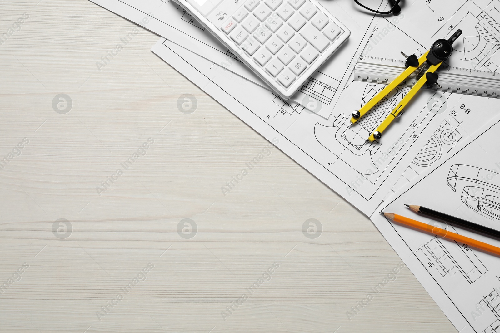 Photo of Different engineering drawings, pencils, calculator and divider on wooden table, flat lay. Space for text