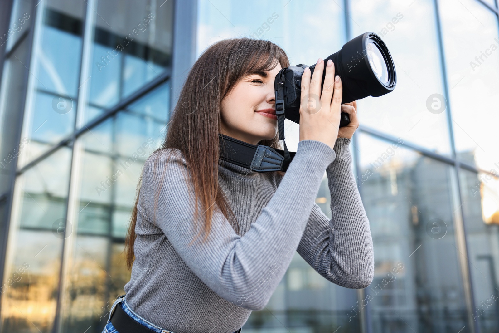 Photo of Professional photographer taking picture with camera outdoors