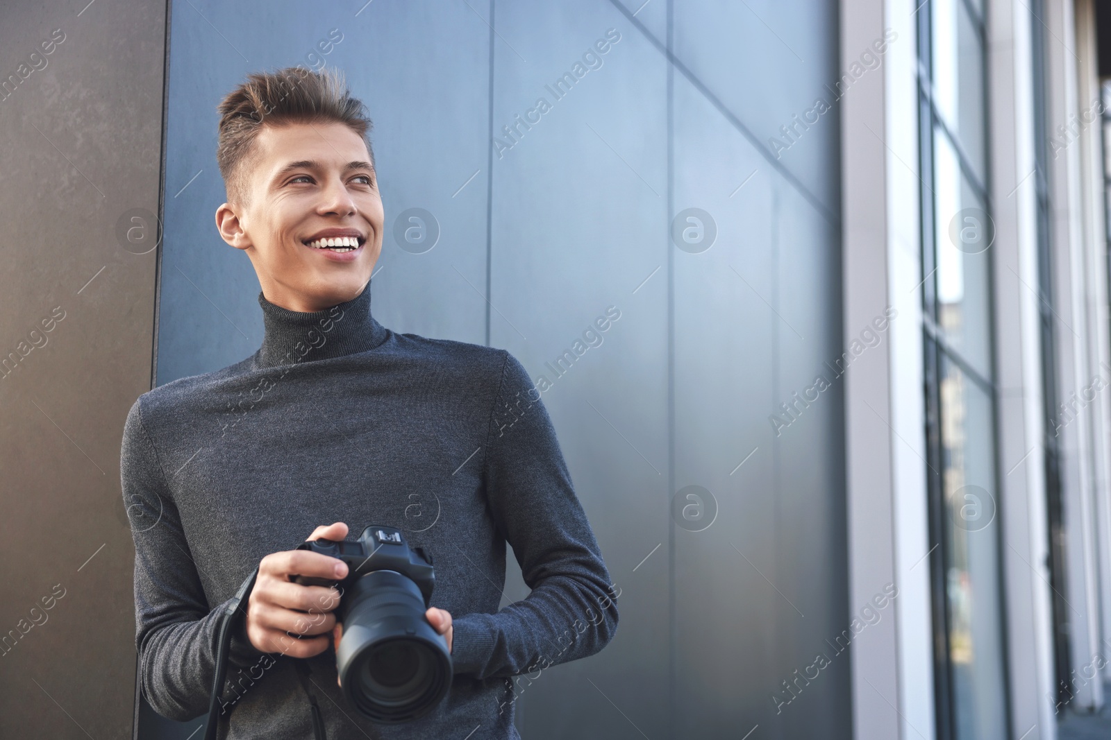 Photo of Professional photographer with camera near building outdoors. Space for text