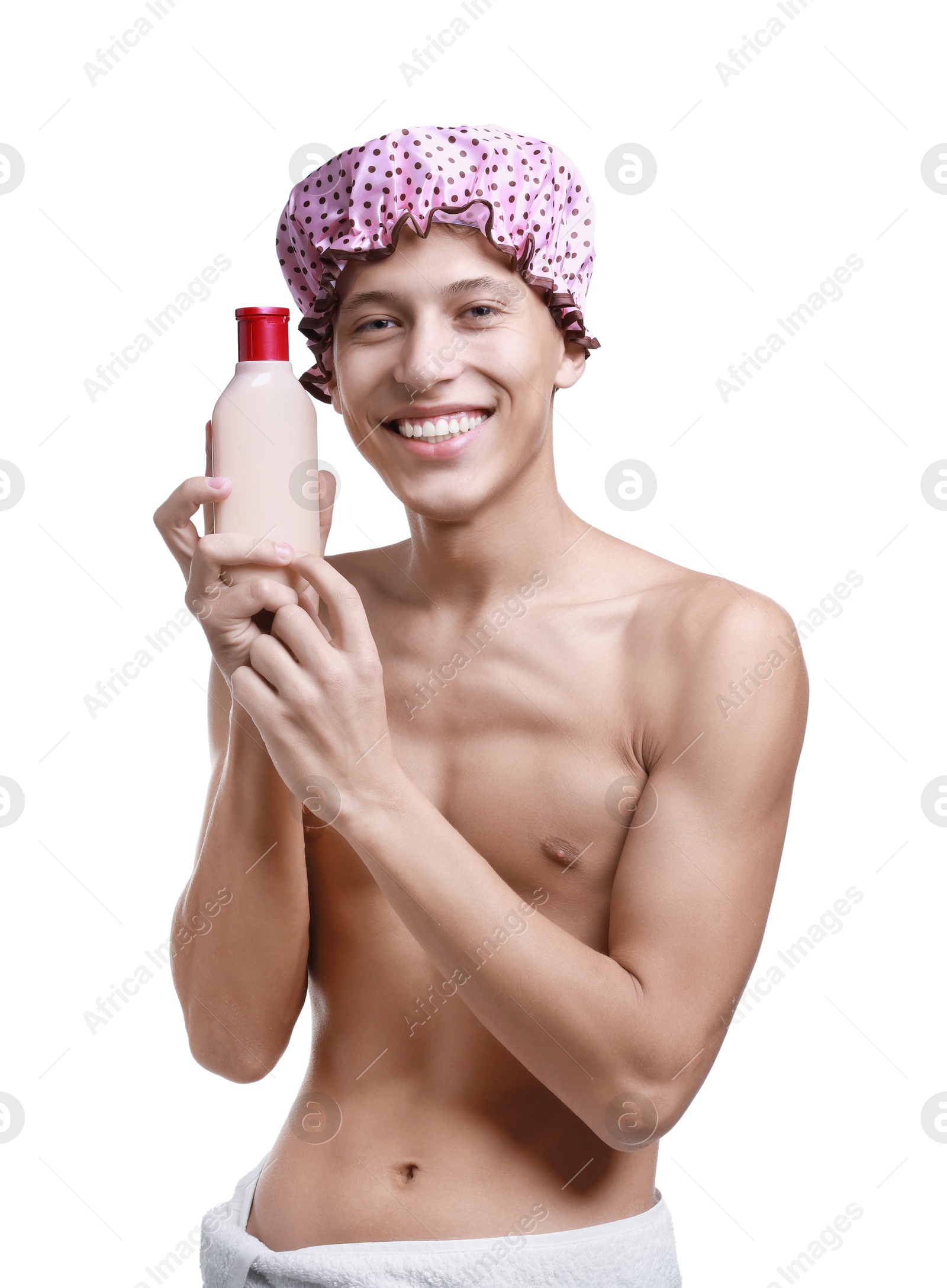 Photo of Happy man with pink shower cap and shampoo on white background