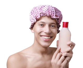 Photo of Happy man with pink shower cap and shampoo on white background