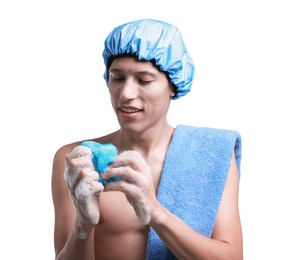 Photo of Happy man in shower cap with towel and mesh sponge on white background