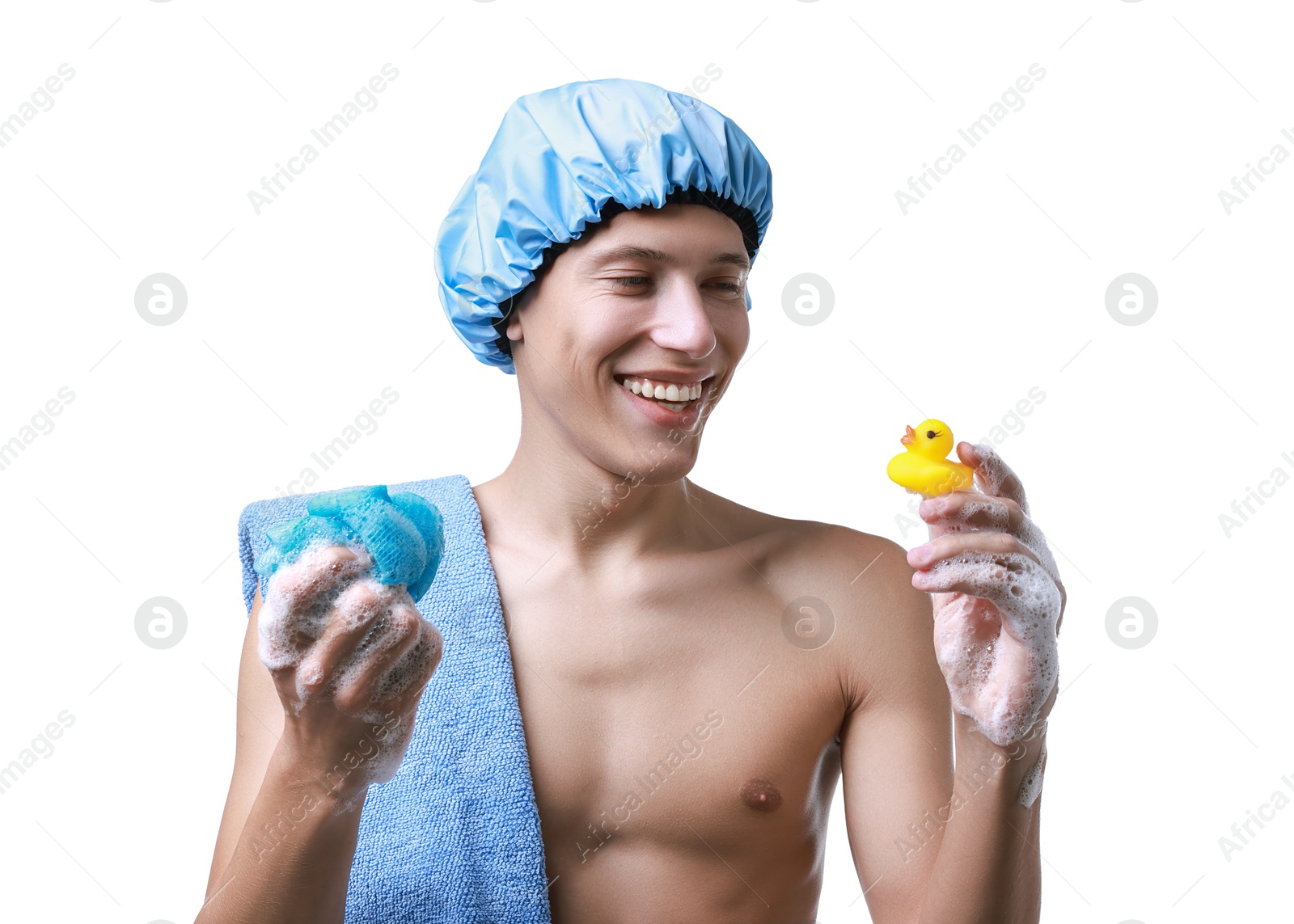 Photo of Happy man with shower cap, towel, bath duck and mesh sponge on white background