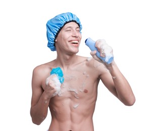 Photo of Man with shower cap, mesh sponge and shampoo singing on white background